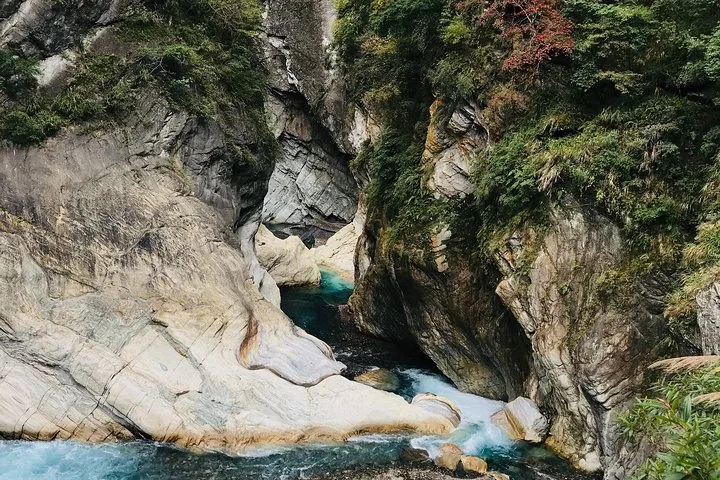 Turquoise river flowing through narrow, steep marble cliffs in Taroko Gorge.