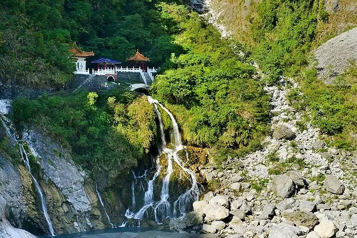 A scenic waterfall cascading down rocky terrain near Eternal Spring Shrine in Taroko.
